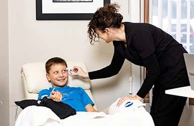 Child having his temperature check while getting an infusion Child having his temperature check while getting an infusion