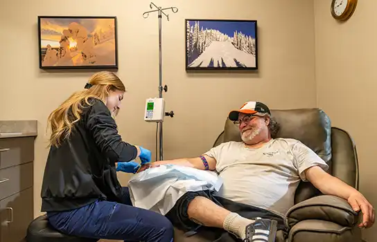 Nurse helping an infusion patient