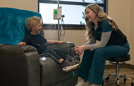 Nurse talking to a child at intake